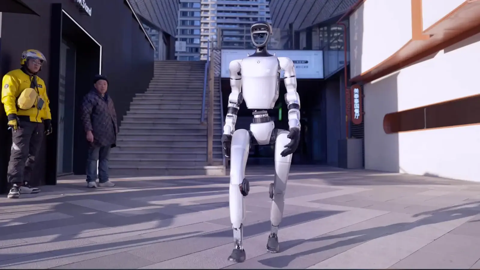 Unitree G1 humanoid robot walking through an urban plaza, official footage