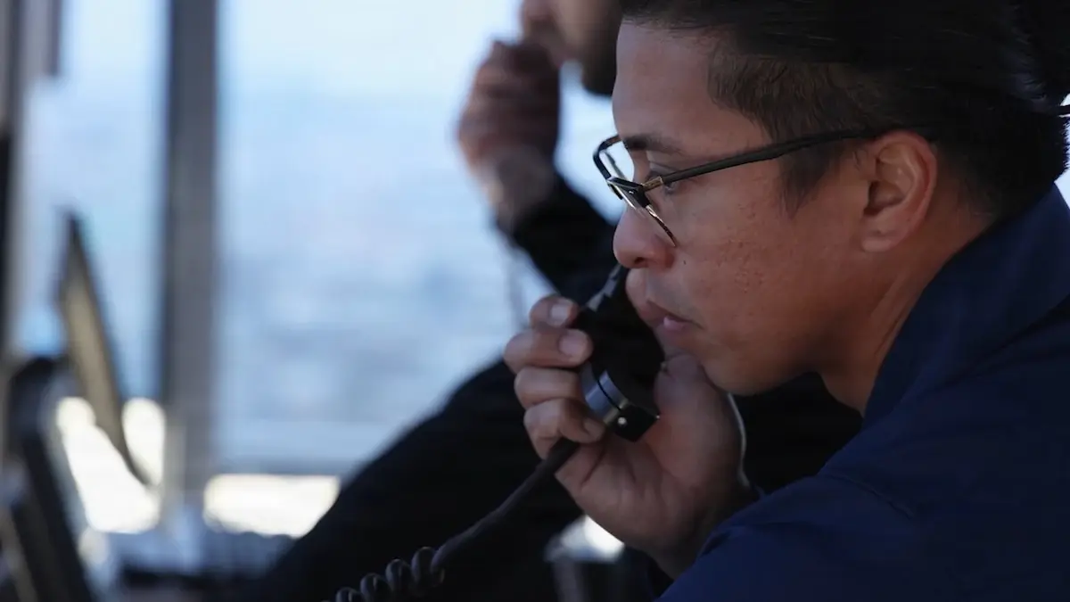 An air traffic controller works in a control tower during an FAA inspection