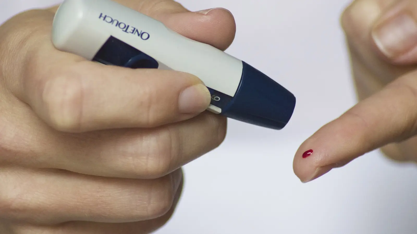 Using a lancing device to obtain a blood sample for a glucose test