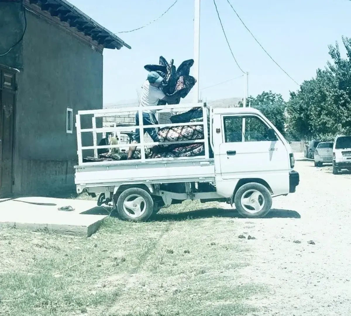 Truck loaded with furniture and household belongings in a courtyard