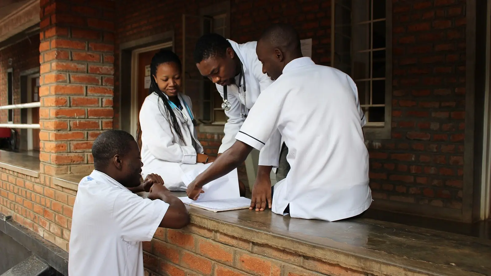 Medical workers discussing documents, illustrative photo